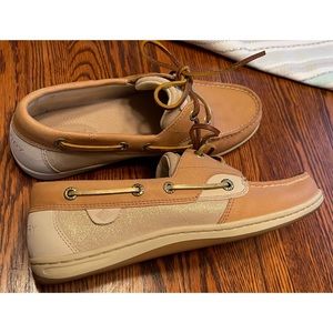 Sperry boat shoes with gold shimmer on the sides and the and top flap